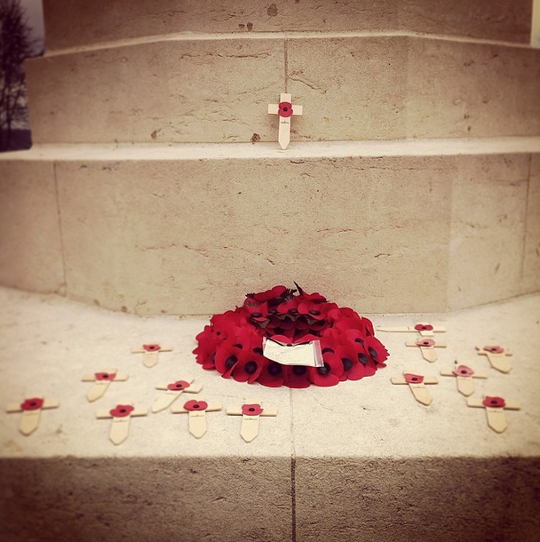 Thiepval Memorial. A wreath of poppies and several small crosses bearing poppies have been placed on the Memorial.