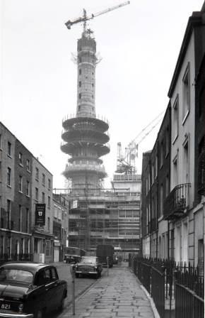 The tower is shown taking shape - there is a crane stationed on the very top. 