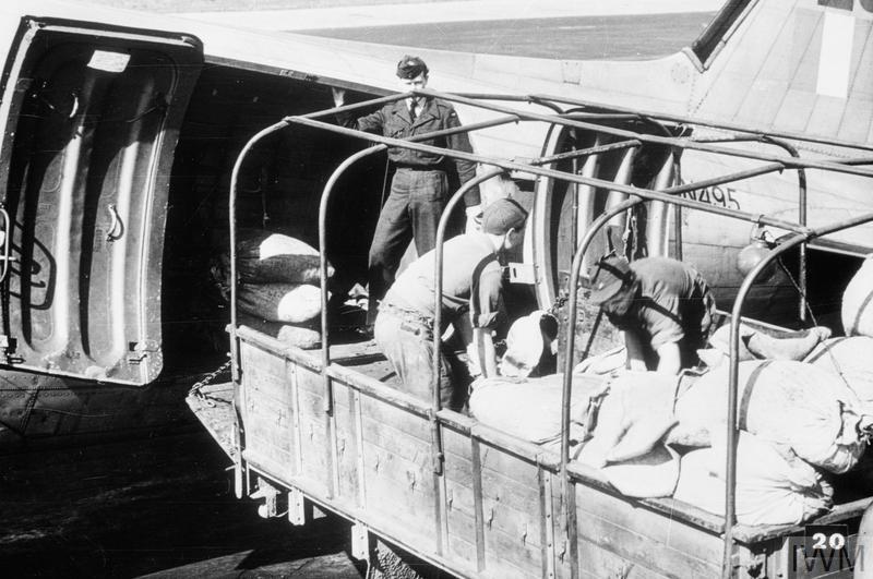 German civilians unload supplies from a Douglas Dakota of Royal Air Force Transport Command at RAF Gatow during the Berlin Airlift,