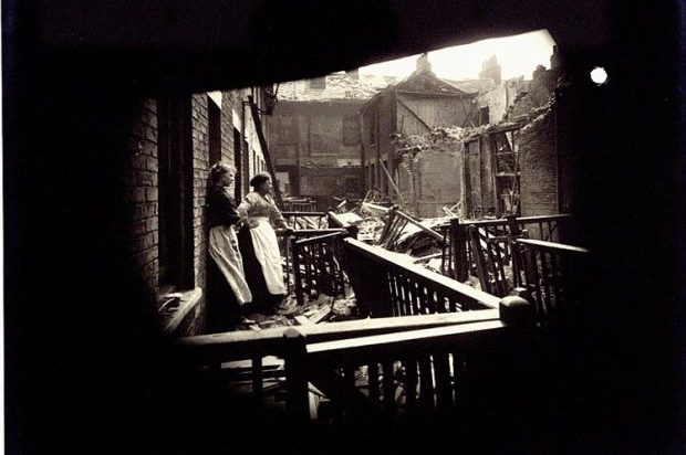 Damage caused by the raid to Edwin Place, Porter Street, Hull, 1916. Two women stand together outside a house looking upon a scene of devastation. 