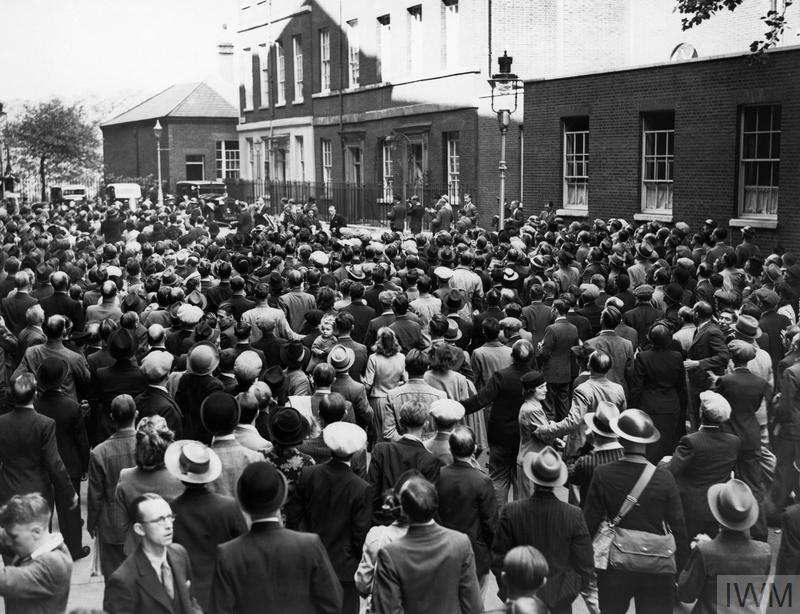 A crowd of civilians outside a very old 10 Downing Street