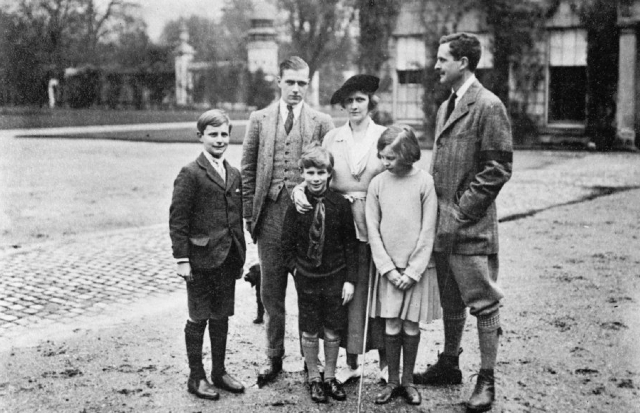 Nancy Astor in a family portrait in front of a family home.