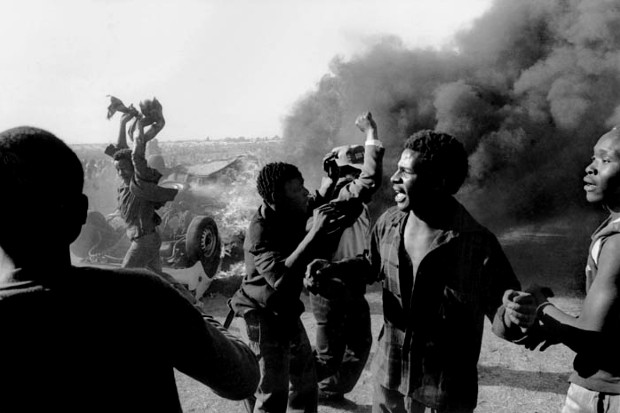 A protest happening, people protesting in front of smoke