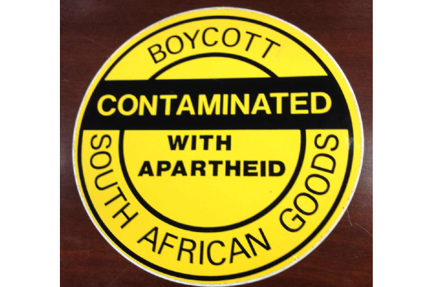 A stick saying, Boycott South African Good, Contaminated with Apartheid